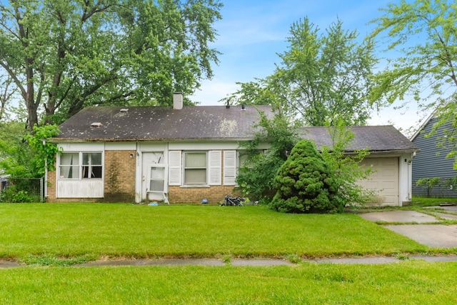 2124 218th St, Sauk Village, IL 60411 - view of front facade with a chimney, concrete driveway, a front yard, a garage, and brick siding