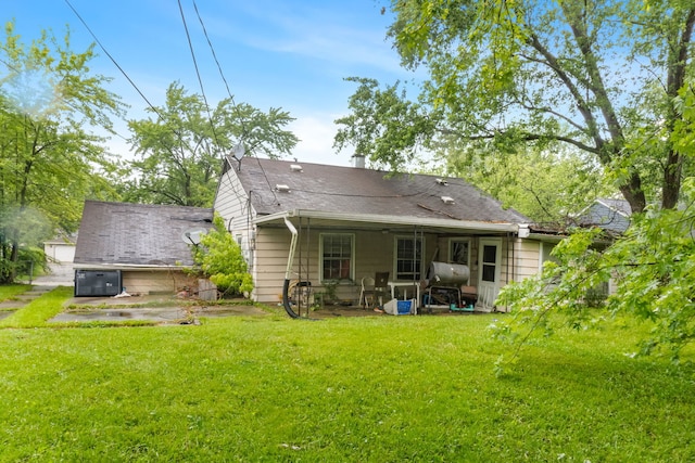 2124 218th St, Sauk Village, IL 60411 - rear view of house with a lawn, a patio, and a shingled roof