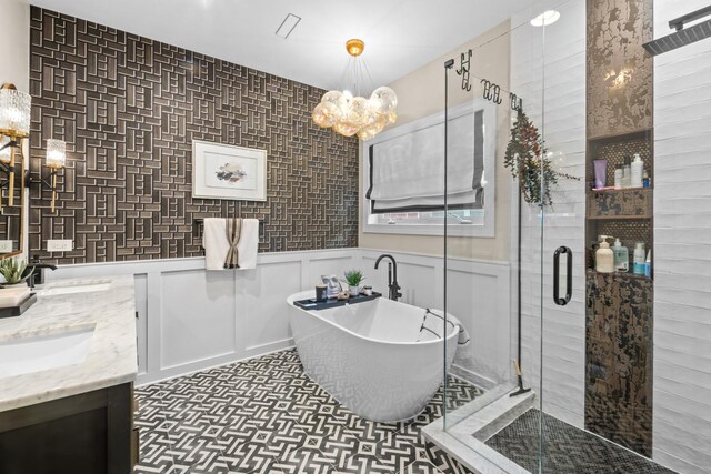 4741 S Drexel Blvd, Chicago, IL 60615 - bathroom with a soaking tub, a shower stall, double vanity, a chandelier, and wainscoting