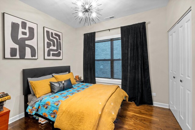 4741 S Drexel Blvd, Chicago, IL 60615 - bedroom featuring a closet, a chandelier, and wood finished floors