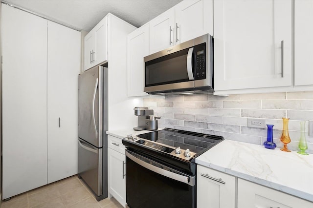 222 N Columbus Dr Unit 1405, Chicago, IL 60601 - kitchen with appliances with stainless steel finishes, tasteful backsplash, and white cabinets