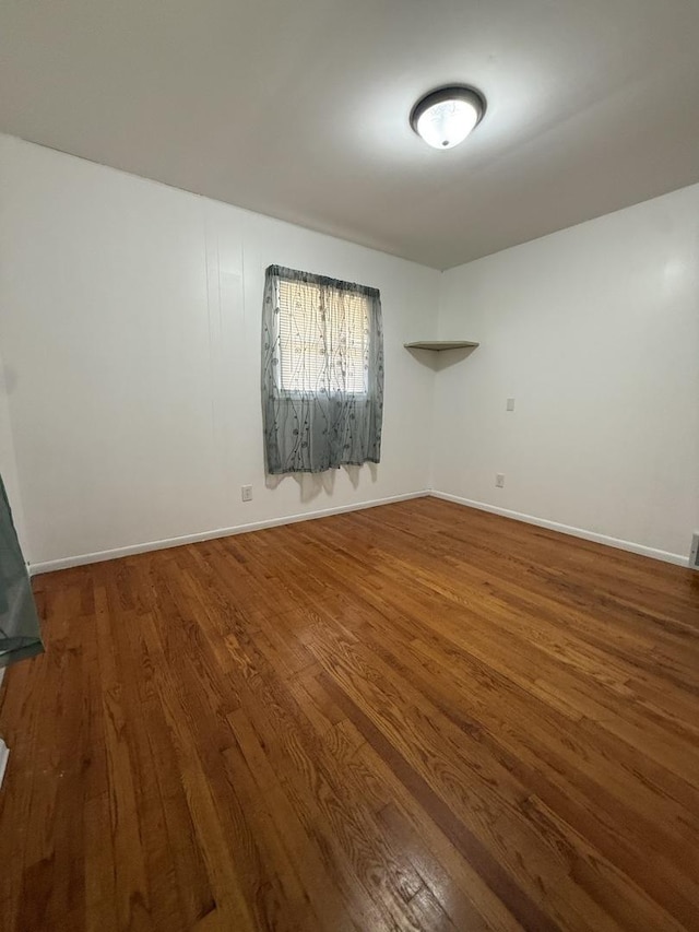 3033 189th St, Lansing, IL 60438 - empty room with wood finished floors and baseboards