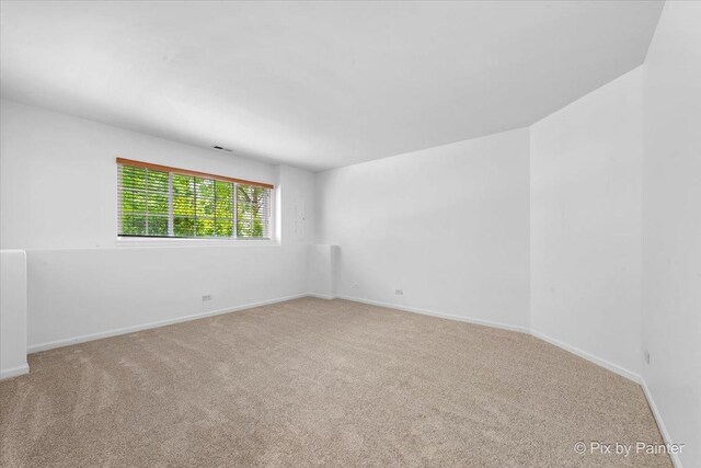 609 Cary Woods Cir, Cary, IL 60013 - spare room featuring carpet and baseboards