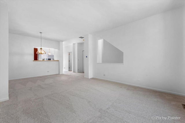 609 Cary Woods Cir, Cary, IL 60013 - unfurnished living room featuring light colored carpet and a chandelier