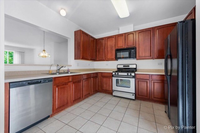 609 Cary Woods Cir, Cary, IL 60013 - kitchen with black appliances, light countertops, light tile patterned flooring, and hanging light fixtures