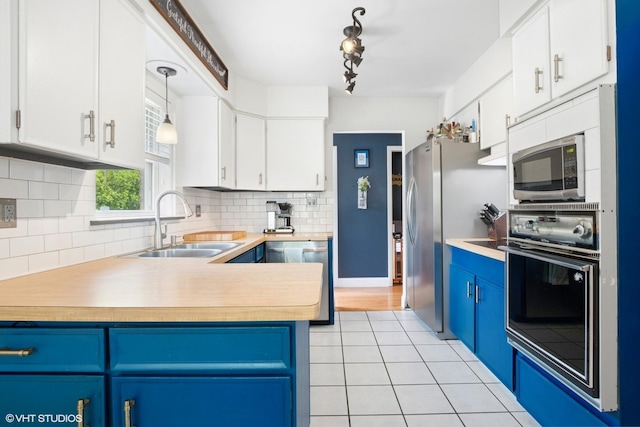 10824 Lavergne Ave, Oak Lawn, IL 60453 - kitchen with appliances with stainless steel finishes, blue cabinetry, light countertops, backsplash, and white cabinets