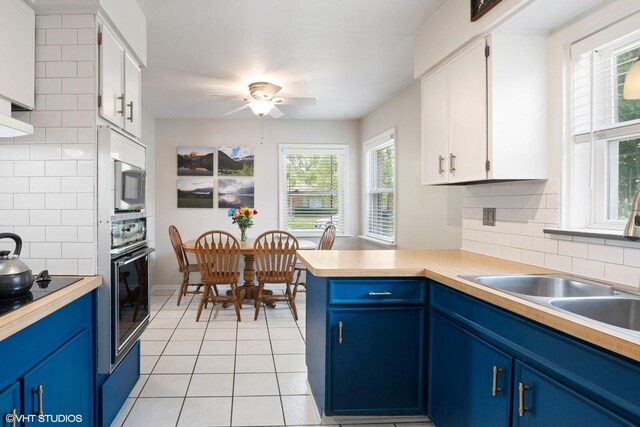 10824 Lavergne Ave, Oak Lawn, IL 60453 - kitchen with blue cabinets, oven, and backsplash