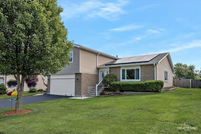 209 Surrey Dr, Carol Stream, IL 60188 - tri-level home with brick siding, asphalt driveway, solar panels, and an attached garage