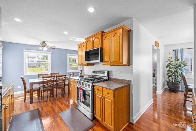 209 Surrey Dr, Carol Stream, IL 60188 - kitchen featuring appliances with stainless steel finishes, dark wood-type flooring, brown cabinetry, ceiling fan, and recessed lighting