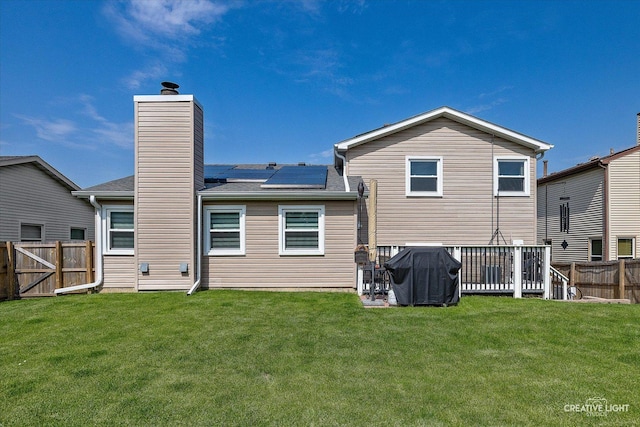 209 Surrey Dr, Carol Stream, IL 60188 - rear view of property featuring solar panels, a fenced backyard, and a chimney