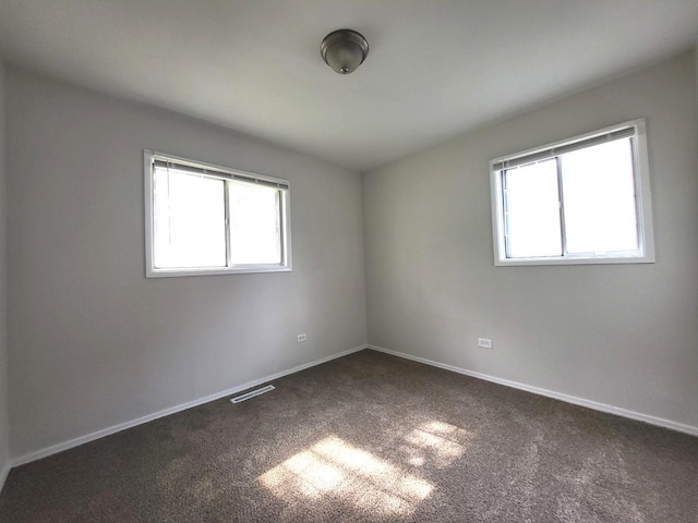2313 Joppa Ave, Zion, IL 60099 - spare room featuring dark carpet and baseboards