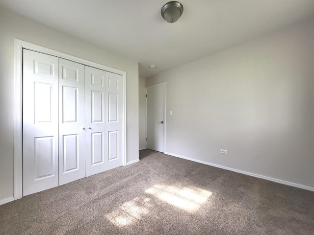 2313 Joppa Ave, Zion, IL 60099 - unfurnished bedroom featuring dark carpet and a closet