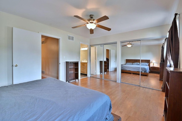 1340 Charger Ct, Carol Stream, IL 60188 - bedroom with two closets, light wood-style floors, and a ceiling fan