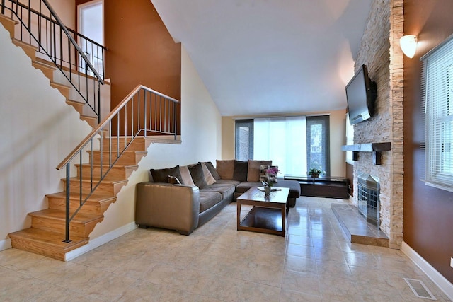 1340 Charger Ct, Carol Stream, IL 60188 - living area with a stone fireplace, stairway, tile patterned flooring, and a high ceiling