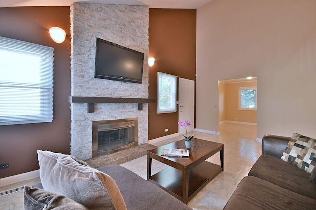 1340 Charger Ct, Carol Stream, IL 60188 - tiled living room featuring a stone fireplace and a high ceiling