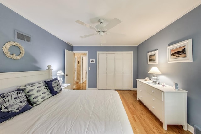 222 Cornell Ave, Des Plaines, IL 60016 - bedroom featuring a closet, light wood finished floors, ornamental molding, and ceiling fan