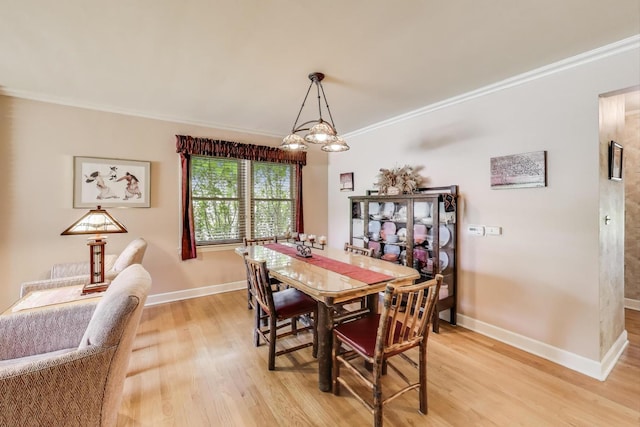 222 Cornell Ave, Des Plaines, IL 60016 - dining space featuring light wood finished floors, ornamental molding, and a chandelier