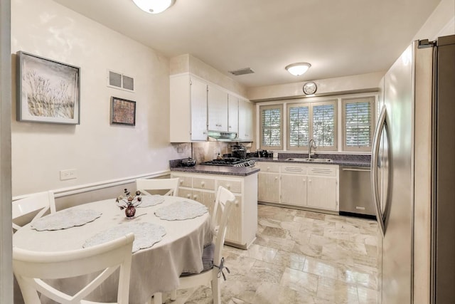 222 Cornell Ave, Des Plaines, IL 60016 - kitchen with appliances with stainless steel finishes, dark countertops, white cabinetry, a peninsula, and light stone finish floors