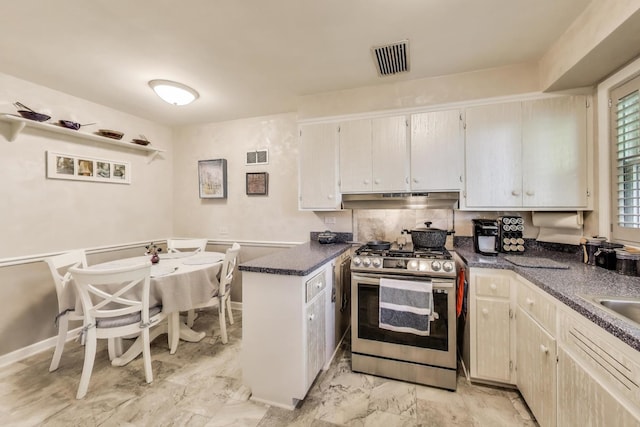222 Cornell Ave, Des Plaines, IL 60016 - kitchen featuring gas range, under cabinet range hood, dark countertops, light marble finish floors, and a peninsula