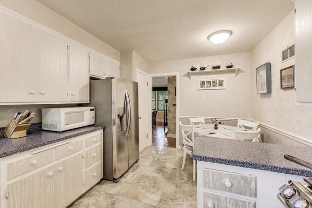 222 Cornell Ave, Des Plaines, IL 60016 - kitchen featuring white microwave, stainless steel refrigerator with ice dispenser, and dark countertops