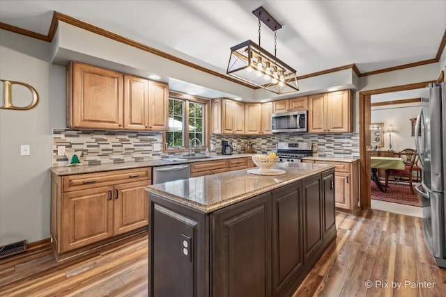 2N445 Beith Rd, Elburn, IL 60119 - kitchen with stainless steel appliances, light wood finished floors, crown molding, and tasteful backsplash