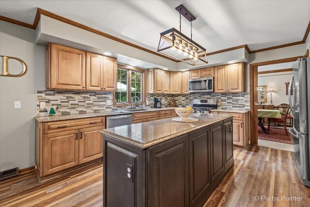 2N445 Beith Rd, Elburn, IL 60119 - kitchen featuring stainless steel appliances, light wood-type flooring, ornamental molding, and decorative backsplash