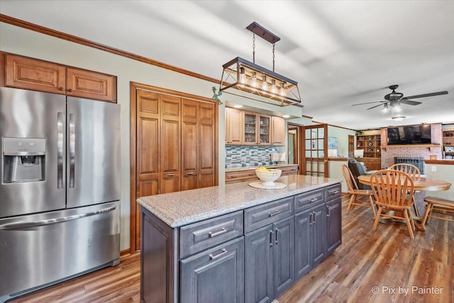 2N445 Beith Rd, Elburn, IL 60119 - kitchen featuring stainless steel fridge, wood finished floors, ceiling fan, backsplash, and a kitchen island