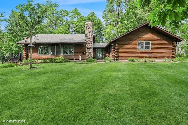 N1508 Wildwood Rd, Linn, WI 53147 - rear view of house featuring log exterior, a yard, and a chimney