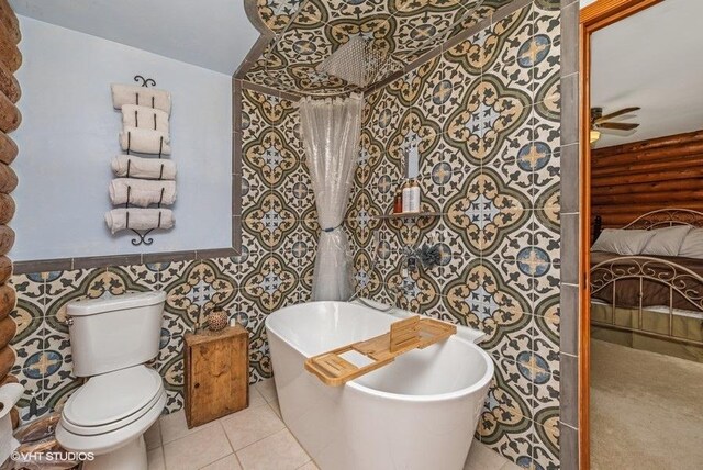 N1508 Wildwood Rd, Linn, WI 53147 - ensuite bathroom with a soaking tub, tile patterned floors, a ceiling fan, tile walls, and wainscoting