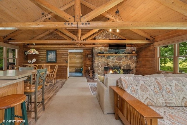 N1508 Wildwood Rd, Linn, WI 53147 - living area with a wood ceiling with exposed beams, log walls, a stone fireplace, and high vaulted ceiling