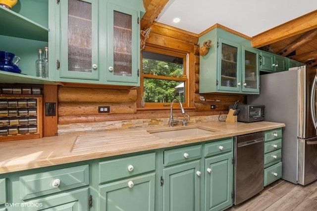 N1508 Wildwood Rd, Linn, WI 53147 - kitchen with stainless steel appliances, rustic walls, green cabinetry, and light countertops