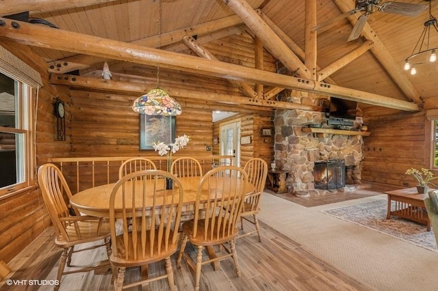 N1508 Wildwood Rd, Linn, WI 53147 - dining room with a wood ceiling with exposed beams, rustic walls, wood finished floors, high vaulted ceiling, and a fireplace