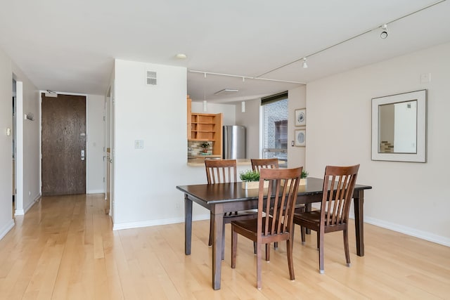 201 E Chestnut St Unit 21F, Chicago, IL 60611 - dining room with track lighting and light wood-style flooring