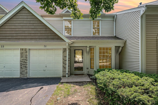 31 E Shagbark Ln, Streamwood, IL 60107 - view of front facade featuring asphalt driveway, an attached garage, and brick siding