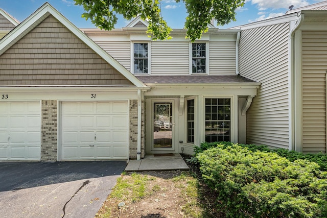 31 E Shagbark Ln, Streamwood, IL 60107 - view of front facade with asphalt driveway, an attached garage, and brick siding