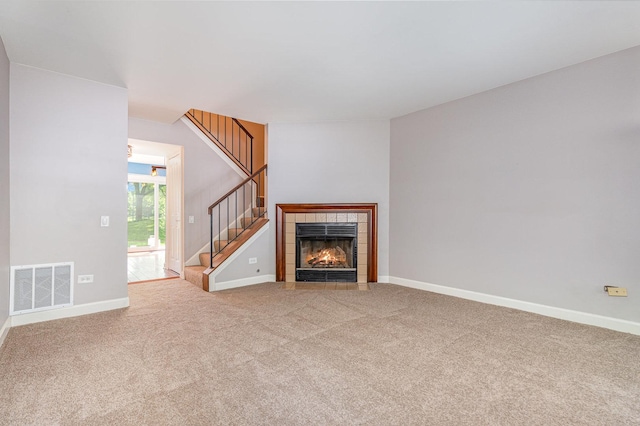 31 E Shagbark Ln, Streamwood, IL 60107 - unfurnished living room with carpet flooring, stairs, and a tiled fireplace
