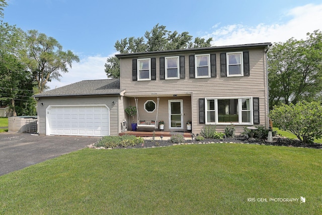 21136 W Engle Dr, Lake Villa, IL 60046 - view of front of property featuring covered porch, driveway, a garage, and a front lawn