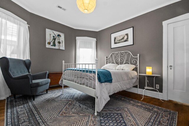 7439 N Maplewood Ave, Chicago, IL 60645 - bedroom with wood finished floors and ornamental molding