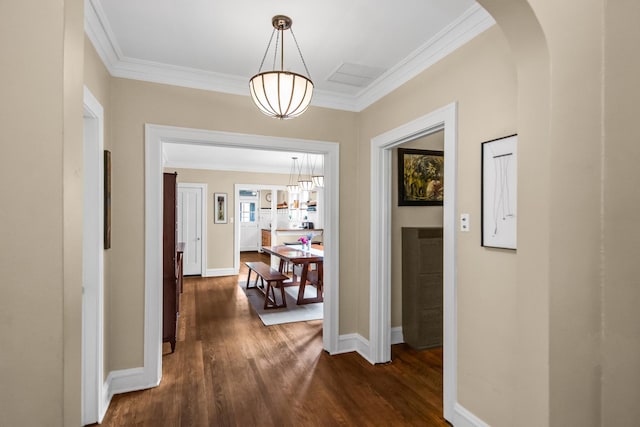 7439 N Maplewood Ave, Chicago, IL 60645 - corridor with crown molding, dark wood-style floors, a chandelier, and arched walkways