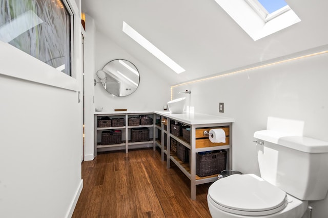 7439 N Maplewood Ave, Chicago, IL 60645 - bathroom featuring a skylight, wood finished floors, and vaulted ceiling