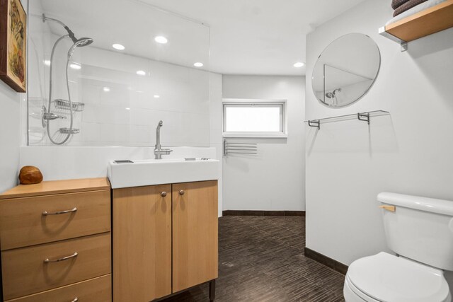 7439 N Maplewood Ave, Chicago, IL 60645 - bathroom with vanity, recessed lighting, a shower, and wood finished floors