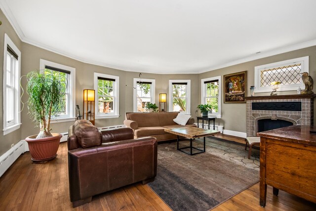7439 N Maplewood Ave, Chicago, IL 60645 - living area featuring plenty of natural light, a baseboard radiator, wood finished floors, a fireplace, and ornamental molding