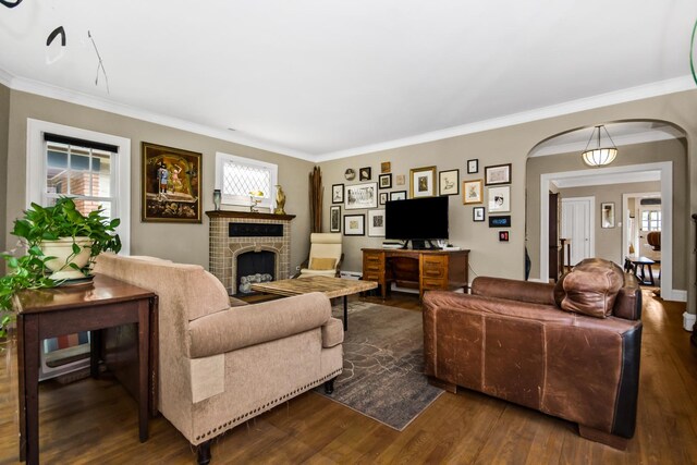7439 N Maplewood Ave, Chicago, IL 60645 - living room with arched walkways, a fireplace, dark wood-style floors, ornamental molding, and an office area