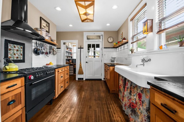 7439 N Maplewood Ave, Chicago, IL 60645 - kitchen with black gas range oven, open shelves, wall chimney exhaust hood, dark countertops, and recessed lighting