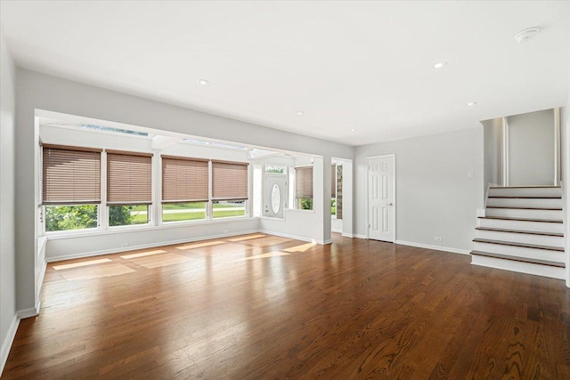 145 N Oakleaf Dr, Addison, IL 60101 - unfurnished living room featuring plenty of natural light, wood finished floors, stairway, and recessed lighting