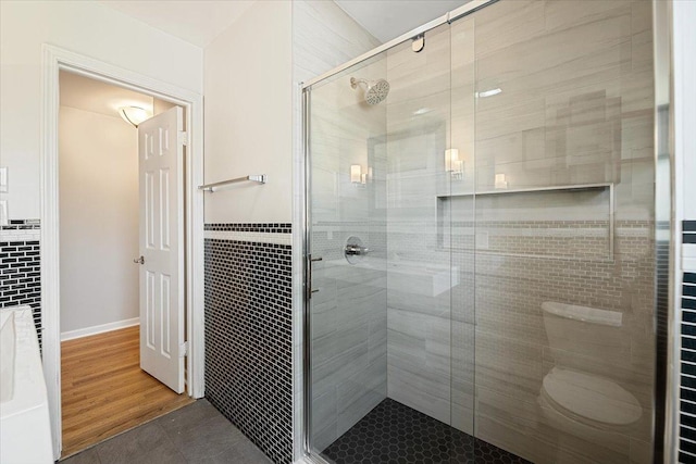 145 N Oakleaf Dr, Addison, IL 60101 - bathroom with a stall shower, tile patterned flooring, and tile walls