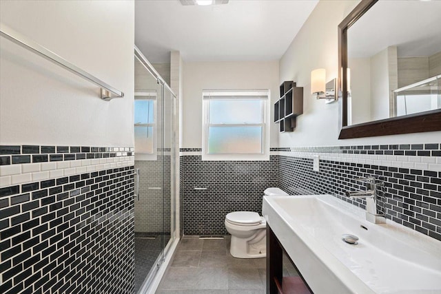 145 N Oakleaf Dr, Addison, IL 60101 - bathroom featuring tile walls, tile patterned floors, a stall shower, vanity, and a wainscoted wall