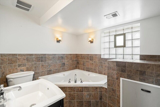 145 N Oakleaf Dr, Addison, IL 60101 - full bath featuring a tub with jets, wainscoting, and tile walls