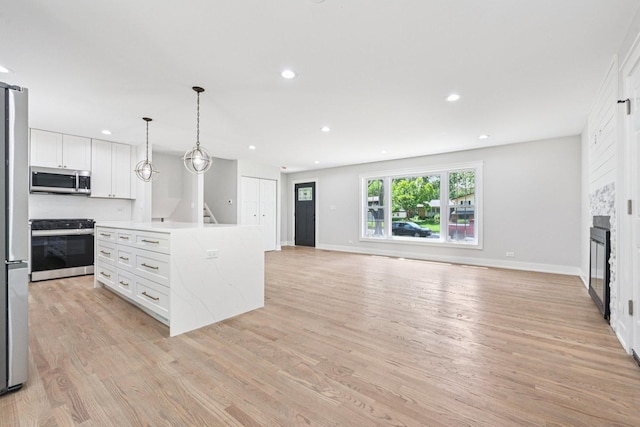 6933 Parkview Dr, Downers Grove, IL 60516 - kitchen with appliances with stainless steel finishes, open floor plan, white cabinetry, light wood-style floors, and recessed lighting