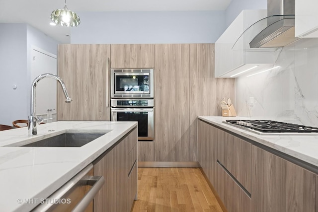 5236 N Kenmore Ave Unit 1N, Chicago, IL 60640 - kitchen with stainless steel appliances, modern cabinets, exhaust hood, and light stone counters